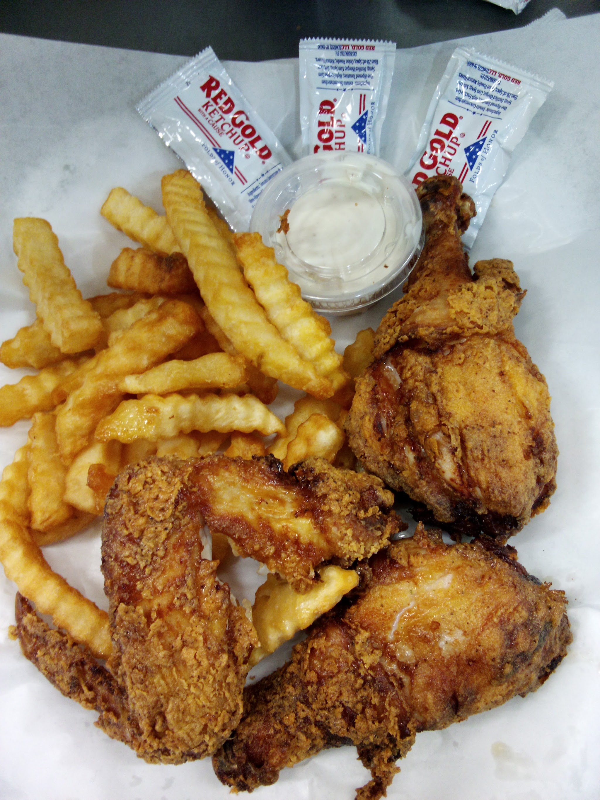 Fried chicken pieces with crinkle-cut fries and ranch
